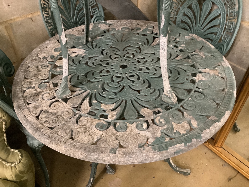 A Victorian style painted aluminium circular garden table with four chairs, table 81cm diameter height 67cm